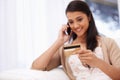 Happy woman, phone call and credit card for banking, online shopping or payment on sofa at home. Female person talking Royalty Free Stock Photo