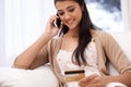 Happy woman, phone call and credit card for online shopping, payment or banking on sofa at home. Female person talking Royalty Free Stock Photo