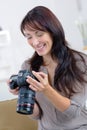 Happy woman photographer takes images with dslr camera