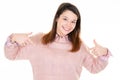 Happy woman in pink sweater pointing fingers to herself Royalty Free Stock Photo