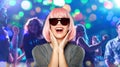 Happy woman in pink wig and sunglasses at party