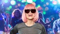 Happy woman in pink wig and sunglasses at party