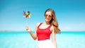 Happy woman with pinwheel over blue sky and sea Royalty Free Stock Photo