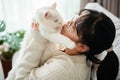 Happy Woman Playing with Cat in Cozy Living Room at Home Royalty Free Stock Photo