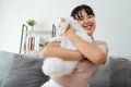 Happy Woman Playing with Cat in Cozy Living Room at Home Royalty Free Stock Photo