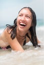 Happy woman playing in the water at the beach Royalty Free Stock Photo