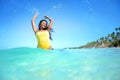 Happy woman playing with water on exotic beach Royalty Free Stock Photo