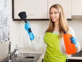 Happy woman with plunger and detergent in kitchen Royalty Free Stock Photo