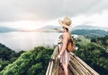 Happy woman pointing the horizon feeling free travelling the world on a inspirational background