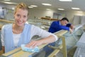 happy woman polishing wooden boards