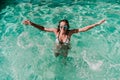 Happy woman at the pool having fun splashing water. Summer and lifestyle Royalty Free Stock Photo