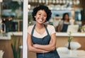 Happy woman, portrait and arms crossed at cafe in small business or waitress at entrance. Confident African female Royalty Free Stock Photo