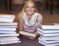 Happy woman, portrait and book on library floor for reading, literature or learning knowledge at bookstore. Female Royalty Free Stock Photo