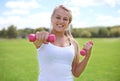 Happy woman, portrait and dumbbells for outdoor exercise, workout or training in nature. Face of young active female Royalty Free Stock Photo