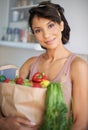 Happy woman, portrait and grocery bag with vegetables or fresh produce in kitchen at home. Female person, shopper or Royalty Free Stock Photo