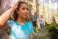 Happy woman portrait with man and girl hiking trail path in forest woods during sunny day.Group of friends people summer Royalty Free Stock Photo