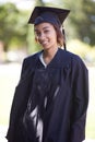 Happy woman, portrait and outdoor graduation for qualification, learning or career ambition in education. Female person