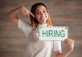 Happy woman, portrait and pointing to hiring sign for small business recruitment, career or job opportunity against