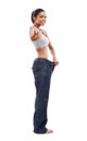 Happy woman, portrait and pointing to lose weight in jeans or decision against a white studio background. Slim female Royalty Free Stock Photo