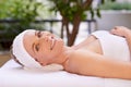 Happy woman, portrait and relax with towel for spa, zen or massage table at hotel or outdoor resort. Face of female Royalty Free Stock Photo