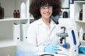 Happy woman, portrait and scientist with microscope in science research, testing or experiment in pharmaceutical lab