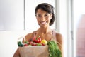 Happy woman, portrait and shopping bag in kitchen with groceries, vegetables or fresh produce at home. Female person Royalty Free Stock Photo