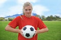 Happy woman, portrait and soccer ball on green grass for sports match, practice or outdoor game. Female person, athlete
