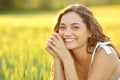 Happy woman posing in a field looking at camera Royalty Free Stock Photo