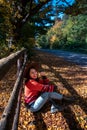 happy woman posing near fence autumn sunny day Royalty Free Stock Photo