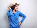 Happy woman posing in profile in glasses and straw hat on blue b Royalty Free Stock Photo