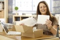 Happy woman with postal packet Royalty Free Stock Photo