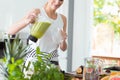 Happy woman pouring green cocktail Royalty Free Stock Photo