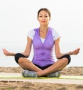 Happy woman practise yoga cross-legged