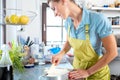 Happy woman preparing heartshape cake