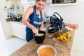 Happy woman is preparing proper meal in the kitchen