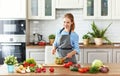 Happy woman preparing vegetable salad in kitchen Royalty Free Stock Photo