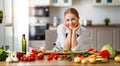 Happy woman preparing vegetable salad in kitchen Royalty Free Stock Photo