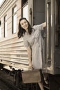 Happy woman pulling face out train door Royalty Free Stock Photo