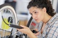 happy woman pumping up tire tyre with bike pump