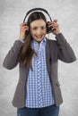 Happy woman puts earphones on her ears Royalty Free Stock Photo