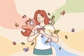Happy woman puts hands on chest standing among flying butterflies and petals symbolizing spring mood