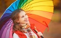 Happy woman with rainbow multicolored umbrella under rain in par Royalty Free Stock Photo