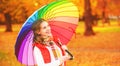 Happy woman with rainbow multicolored umbrella under rain in par Royalty Free Stock Photo