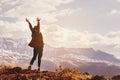 Happy woman with raised hands on background of mountain`s sunset Royalty Free Stock Photo