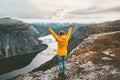 Happy woman raised hands on mountain summit