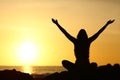 Happy woman raising arms looking at sunrise Royalty Free Stock Photo