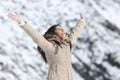 Happy woman raising arms on winter holidays