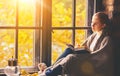 Happy woman reading book by autumn window Royalty Free Stock Photo