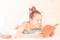 Happy woman reading book while having spa skin scrub treatment Royalty Free Stock Photo