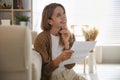 Happy woman reading letter near sofa Royalty Free Stock Photo